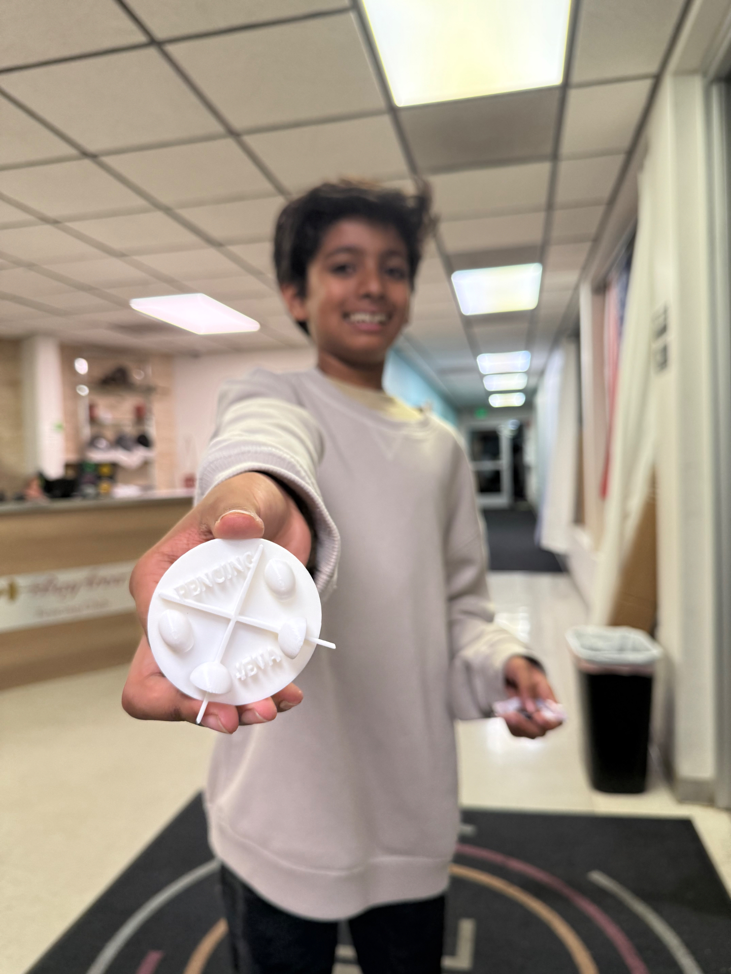 3D-printed 'Fencing 4Eva' medallion — designed by a Sean