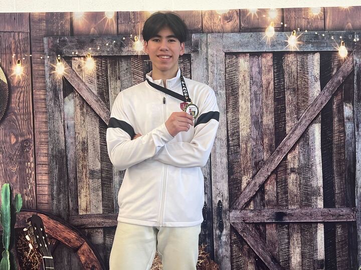 BAFC medalist in white warm-up jacket