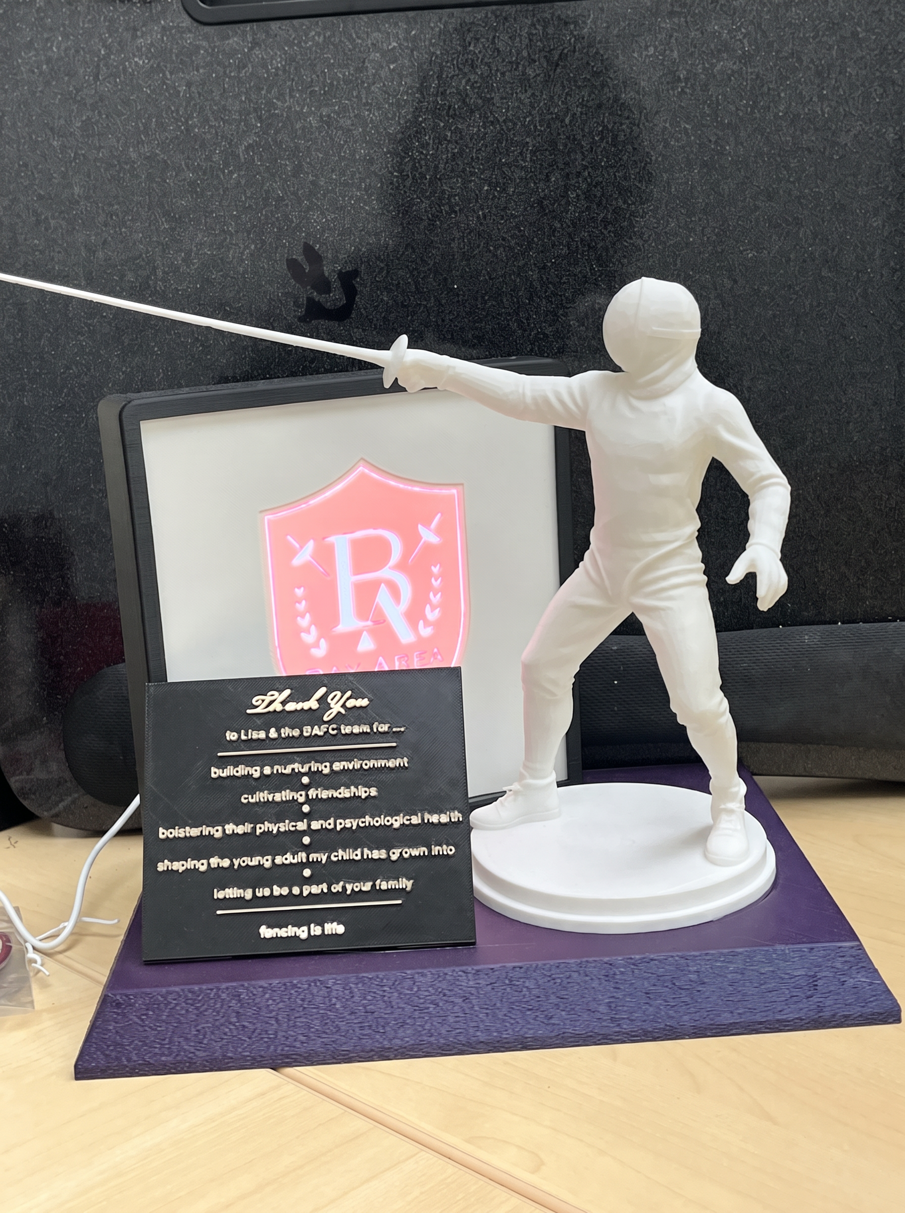 BAFC fencer statue with thank-you plaque and club shield