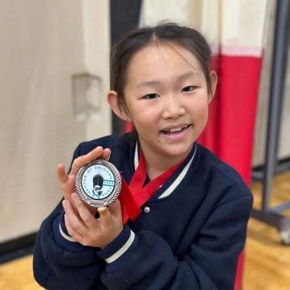 Young BAFC medalist proudly showing her medal