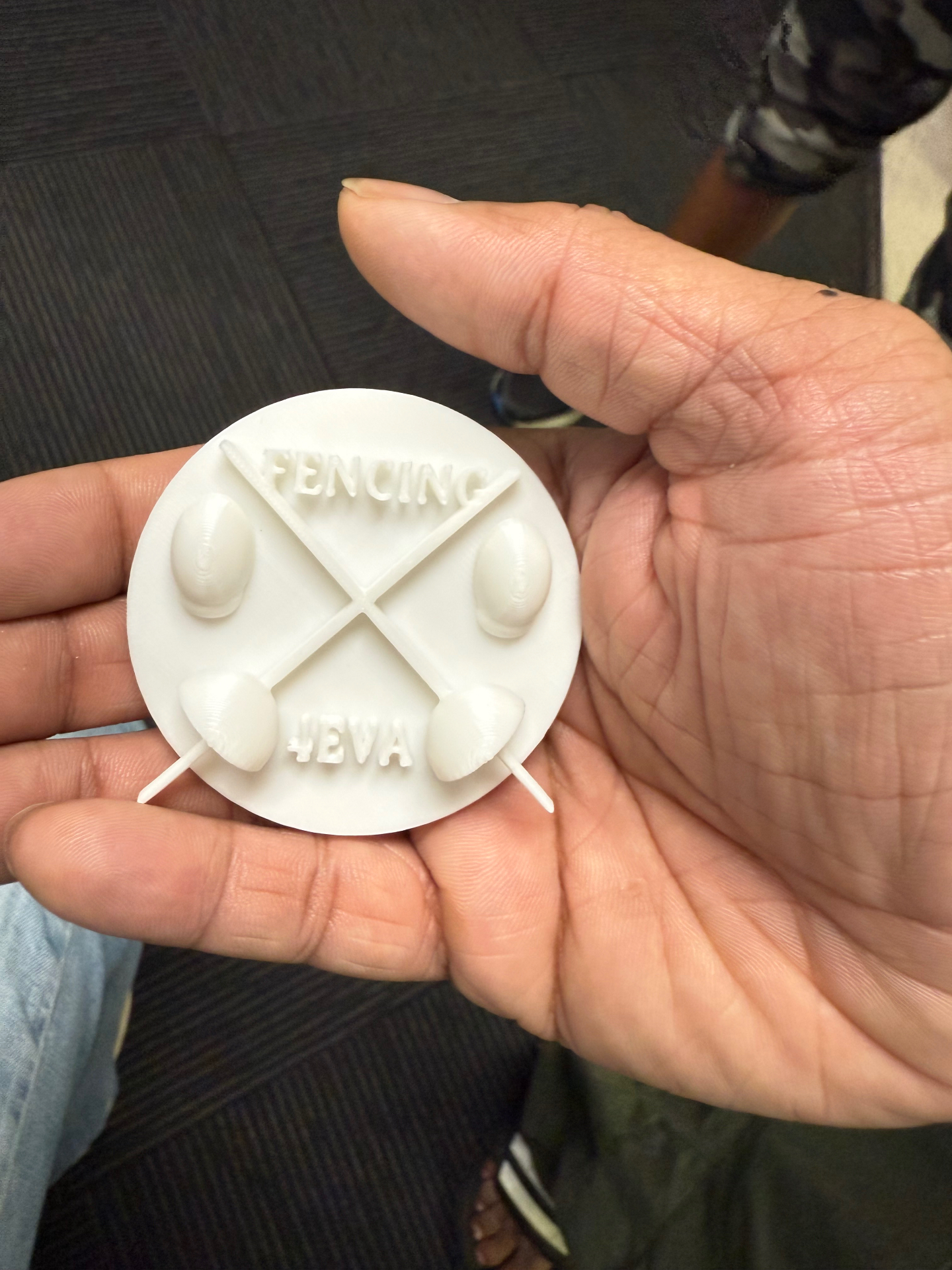 BAFC fencer Sean showcasing a 3D-printed 'Fencing 4Eva' medallion