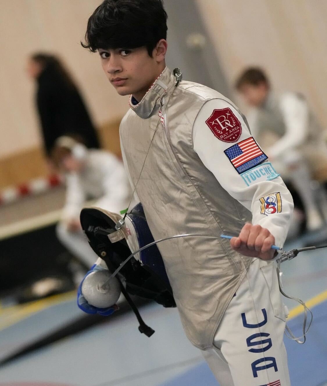 BAFC fencer in USA uniform preparing to compete
