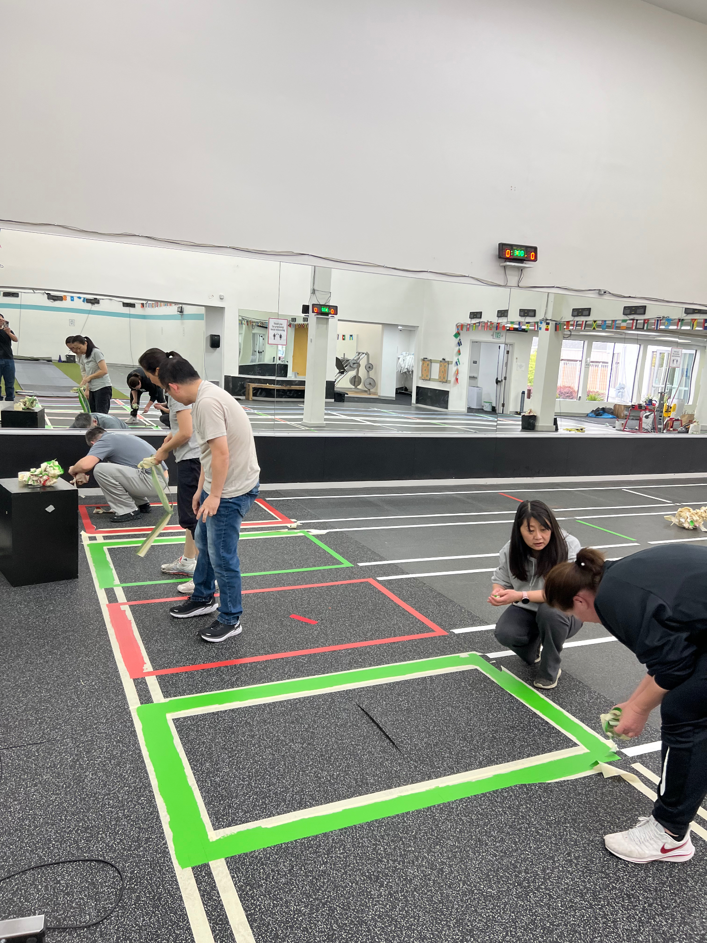 Club build-out — taping fencing strips on the salle floor