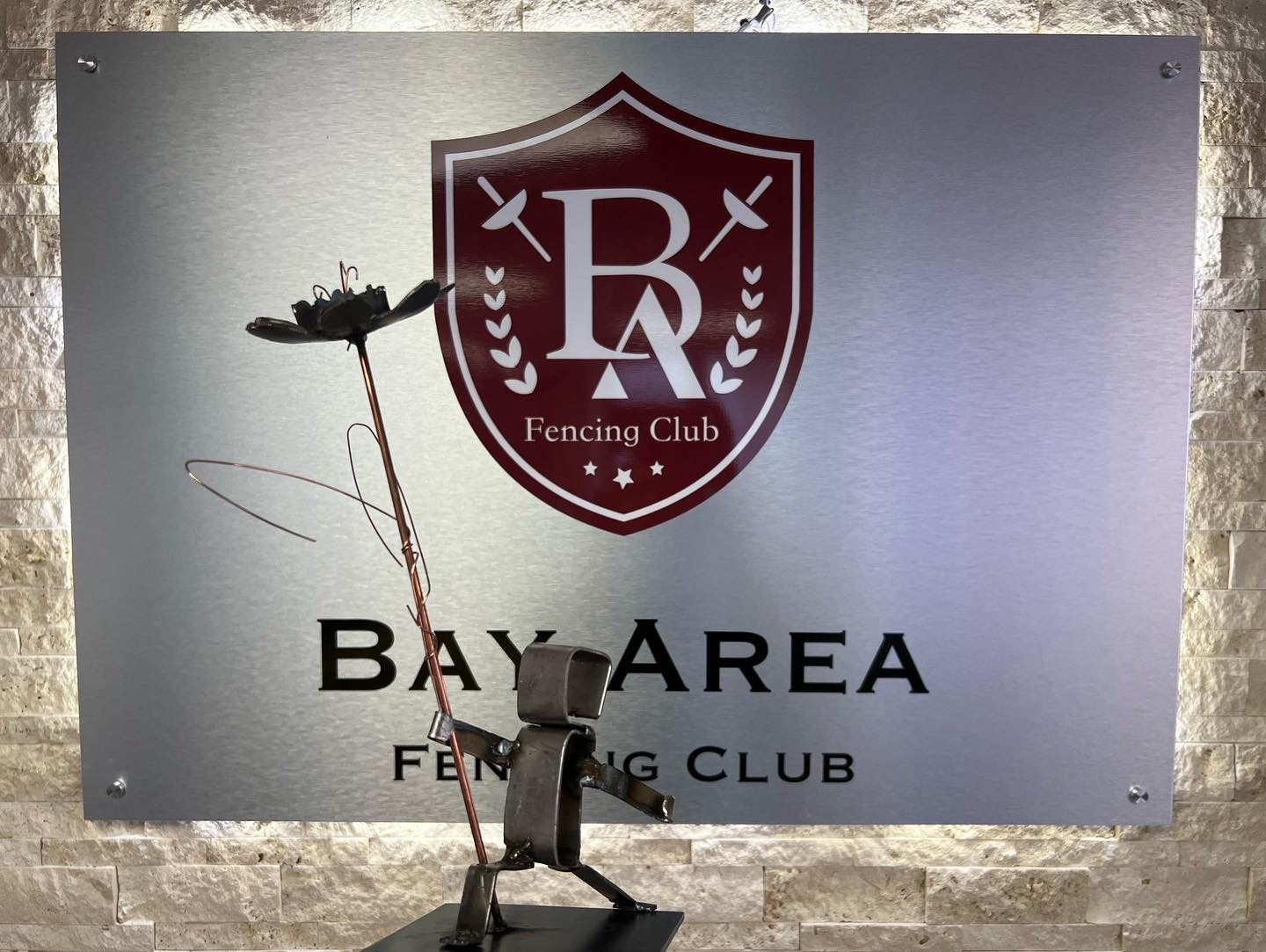 Handcrafted metal fencer sculpture on display at BAFC